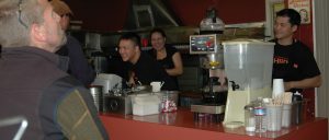 Gary Lew (@Garyat HRDCoffee), Joanna Banks and David Yeung share a moment with customers during the lunch rush.