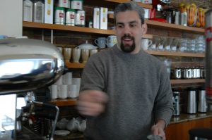 Longtime Georgetown manager Martin Cotignola making a cup of coffee behind the bar