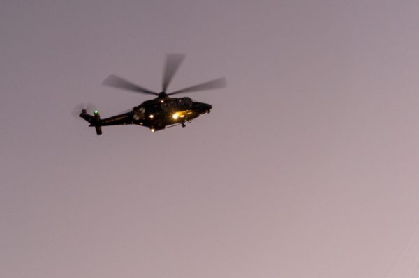 A Maryland State Police helicopter separates from a larger group of helicopters in the "Lost Man" formation. The flight offered a touching tribute over Dulaney Valley Memorial Gardens as the sun began to set during the Detective Sean Suiter funeral. (Michael Jordan)