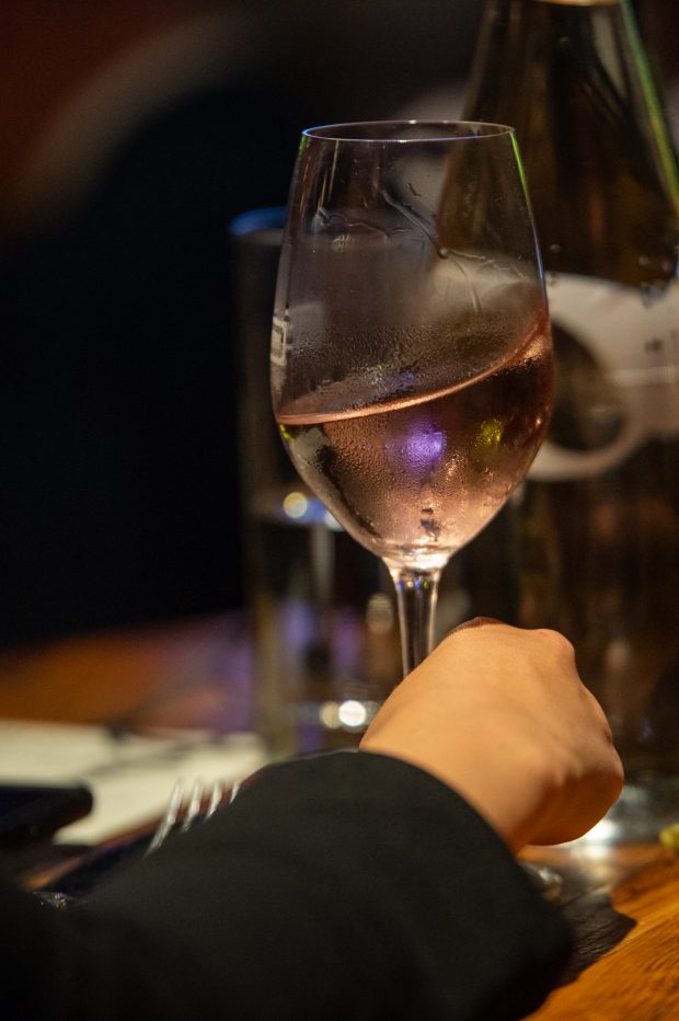 A concert goer swirls win while waiting for Grammy Award winning artist Herb Alpert and Lani Hall to perform at City Winery in Washington DC on on Wednesday May 1, 2019. (PHOTO/Mike Jordan)