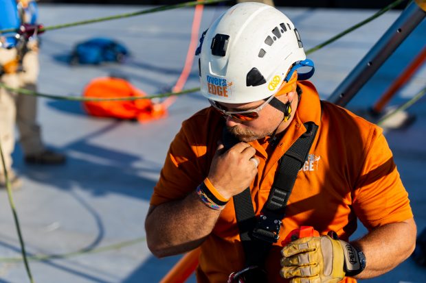 Baltimore, MD - Todd Medeiros from Over the Edge, a fundraising group specializing in high angle rigging, works on high angle rigging on top of 100 N. Charles Street Friday June 14, 2019.