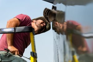 Reading (PA) - Maintenance tech Bryan Costa inspects the exhaust ports of the Warbird Adventures TP-40 Warhawk at the Mid-Atlantic Air Museum WWII Weekend. (Michael Jordan/BPE)