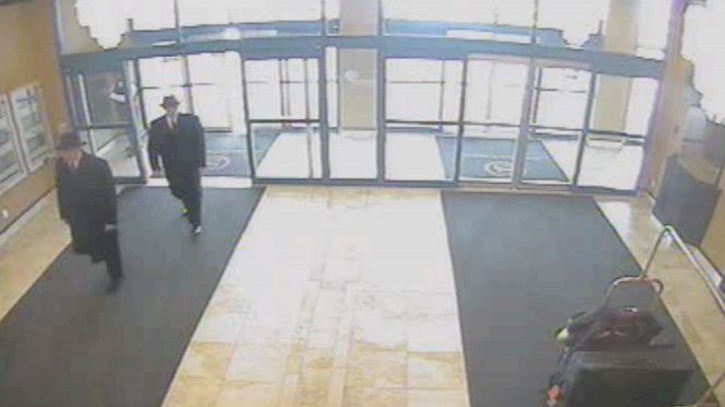 Two mysterious MIB enter a hotel lobby in Niagra Falls