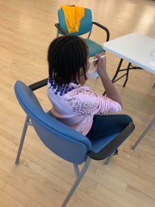 A girl enjoys Taharka Brothers ice cream at a Baltimore YMCA providing care for the children of health care workers. Customers ordering online can donate $8 for ice cream for kids; the company also donates mini-pints.  (Courtesy: Taharka Bros.)