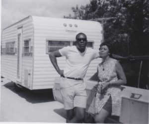Everyone But Two: Benjamin and Frances Graham in front of their travel trailer