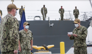 Cmdr. Jeremiah Petersen, right, reads his orders to assume command of USS Fort Worth (LCS 3) from Cmdr. Colin Corridan, left, during a change of command ceremony. Capt. Matthew McGonigle, commander of Littoral Ship Squadron ONE, center, presides over the change of command. (U.S. Navy photo by Lt. j.g. Sheryl Acuna)