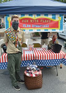 Boy Scout flag burning retirement ceremony: Troop 306 member Jack Callahan manning the flag collection booth at the Catonsville Farmers Market. Anthony C. Hayes)