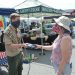 Boy Scout flag burning retirement ceremony: Eagle Scout candidate Jack Callahan accepts a weathered U.S. flag from Arbutus resident Collen Day. (credit Anthony C. Hayes)
