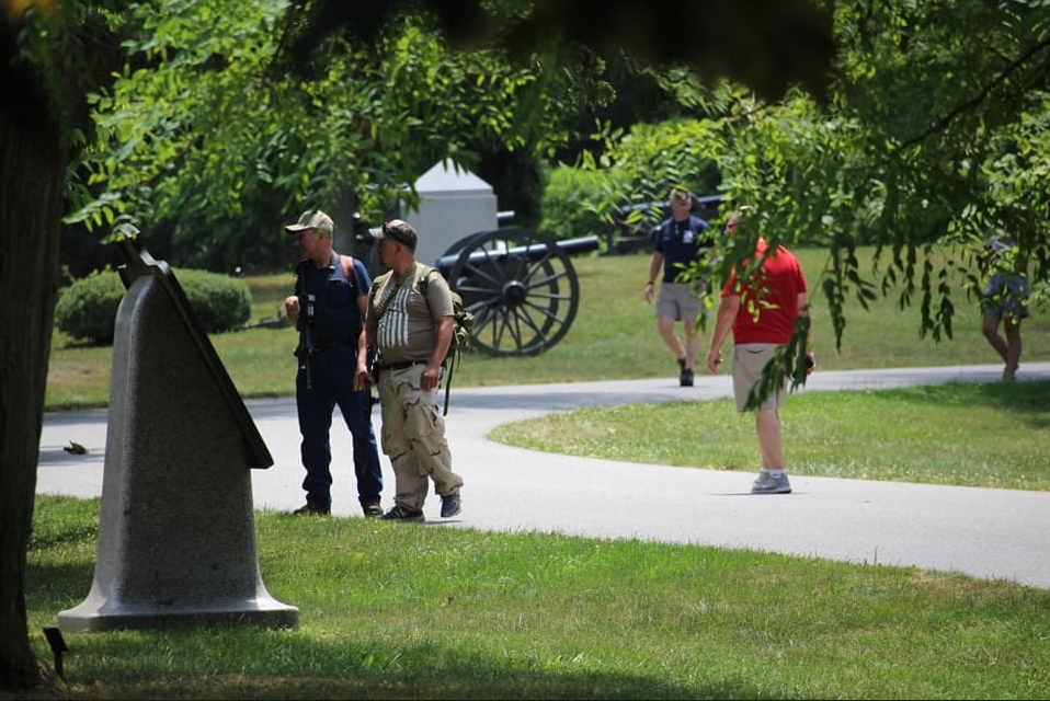Two armed Patriots stop to read an inscription at Gettysburg National Park: July 4, 2020: credit BPE Staff
