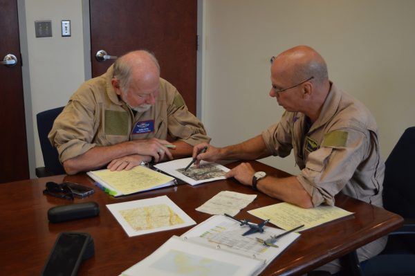 Pilot Peter Hague (r) shows "navigator" Agu Ets the objective of their torpedo mission at the 2021 Commemorative Air Force Warbirds Showcase in Frederick, MD. (credit Anthony C. Hayes/BPE)