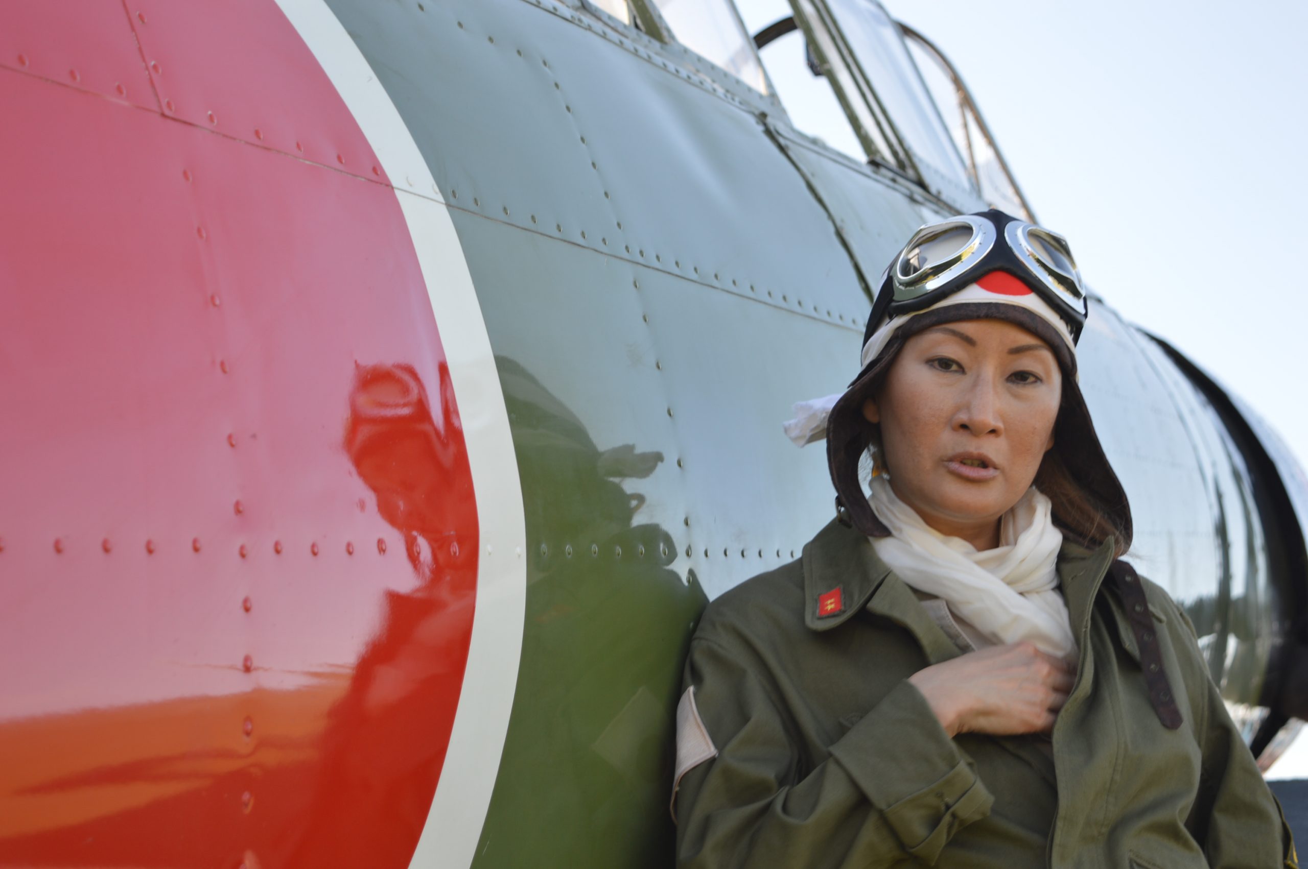 Zero / Kate pilot: Baltimore Post-Examiner contributing photographer Lady Camille donned the authentic garb of a Japanese pilot to pose beside a replica IJN Nakajima B5N2 "Kate" at the 2021 MAAM WWII Weekend. (credit Anthony C. Hayes)