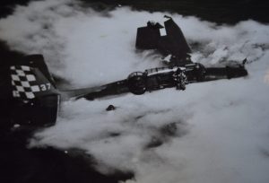 An unknown Navy photographer captured Edward Stepanian (in the water at left) and his pilot (standing on the wing) as they awaited rescue after their overladen TBF Avenger went into the water while trying to take off from the USS Cowpens. It is thought that the rear turret gunner (who also survived the crash) may be in the water or clinging to the wing on the other side of the plane. All three airmen ended up in sickbay after their toxic 30-minute bath of sea water and leaking airplane fuel. Credit: The Edward Stepanian Collection courtesy Lynn Stepanian-Smith.