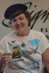 Wearing his sailor cap, Lynn Stepanian-Smith. poses with a picture of her late father Edward Stepanian. (credit Anthony C. Hayes/BPE)