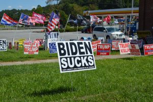 A Biden Sucks yard sign on the lawn of the Trump Store. (credit Anthony C. Hayes)