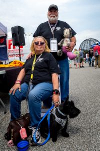 2022 National Fallen Firefighters Foundation Memorial Lap at Dover Motor Speedway: Randy and Rebecca Guise of Driftwood, PA. were in Dover to honor their son Jerome, who perished in a fire in March 2020. The stuffed bear in Randy's arm was constructed by family friend Teresa Nelson from two of Jerome's shirts. (credit Mike Jordan/BPE)