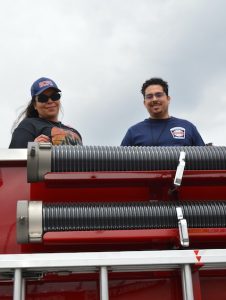 National Fallen Firefighters Foundation Memorial Lap at Dover Motor Speedway, May 1, 2022:Clara N. Fenelon-Lacayo and Santiago Lacayo aboard Engine 12 from North Beach, Maryland. (credit Anthony C. Hayes)