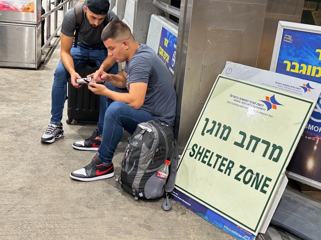 Israelis take shelter during a missile alert at Israel's Ben Gurion International Airport.