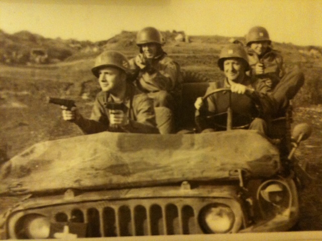 Brothers in Arms: Baltimore's Ace, Larry, and Rock Rosner: Ace Rosner (left front) holding his .45 pistol and his brother Larry’s (right front, behind the wheel) .45 as well. Taken at Anzio, Italy about two weeks before Ace lost his right arm.The two soldiers in the back seat were also from Baltimore. May 1944.
