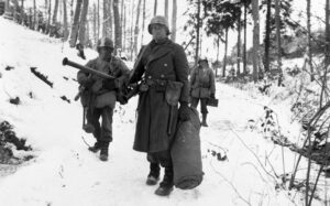 Army engineers emerge from defensive positions in the vicinity of Bastogne, Belgium, after fighting in the Battle of the Bulge. (US Army photo)