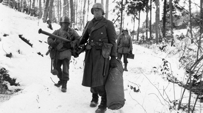 Army engineers emerge from defensive positions in the vicinity of Bastogne, Belgium, after fighting in the Battle of the Bulge. (US Army photo)