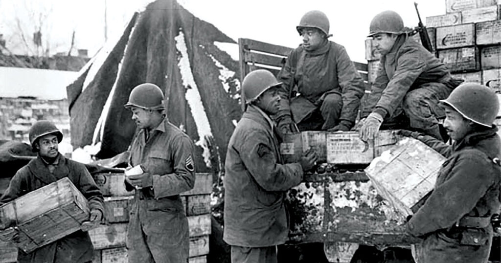 Battle of the Bulge, Red Ball Express: Soldiers from the 4185th Quartermaster Service Company (left to right), Pvt. Harold Hendricks, Staff Sgt. Carl Haines, Sgt. Theodore Cutright, Pvt. Lawrence Buckhalter, Pfc. Horace Deahl, and Pvt. David N. Hatcher, load trucks with rations bound for frontline troops September 1944 in Liege, Belgium. (Photo courtesy of the U.S. Army)