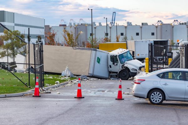 Extensive damage can be seen at the Amazon fulfillment center in Baltimore after sunrise Saturday morning. The damage is a result of a severe weather event late Friday night. Firefighters and special operations teams from Baltimore City Fire Department are seen working to locate and remove a second victim. (Mike Jordan/BPE Photo)