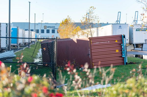 Extensive damage can be seen at the Amazon fulfillment center in Baltimore after sunrise Saturday morning. The damage is a result of a severe weather event late Friday night. Firefighters and special operations teams from Baltimore City Fire Department are seen working to locate and remove a second victim. (Mike Jordan/BPE Photo)