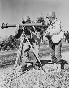 Battle of the Bulge cancellation: American soldiers using a coincidence rangefinder with its distinctive single eyepiece during army maneuvers in the 1940s. (Wikimedia) Vintage army equipent is used in the annual Battle of the Bulge reenactment.