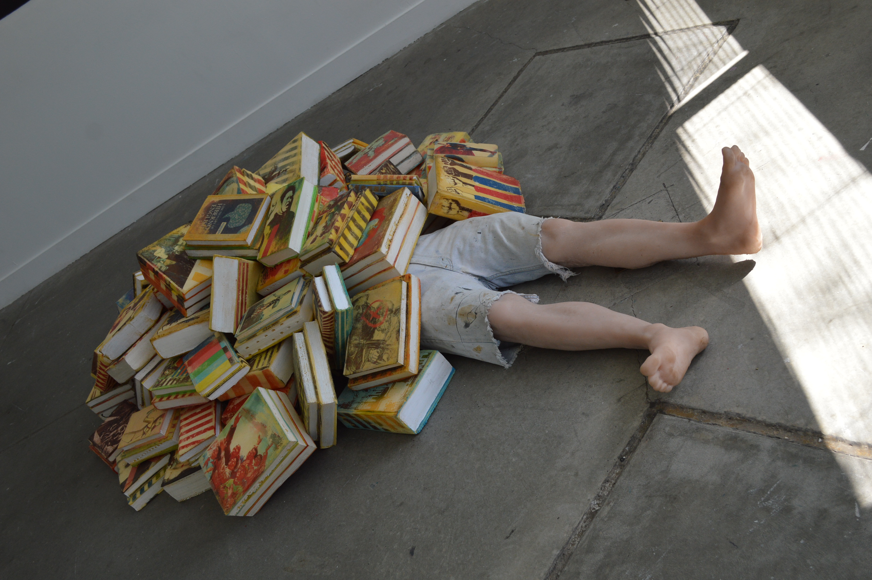 One of th features pieces at the Babble exhibit in Baltimore is "Benjamin" a fake human figure half covered by books is the work of New York artists Alina and Jeff Bliumis. (credit Anthony C. Hayes)
