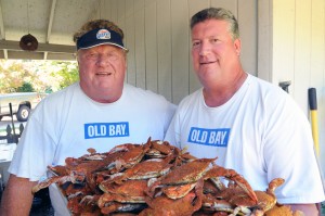 Boog with son J.W. and a tray of steamed blue crabs. (Jim Burger)