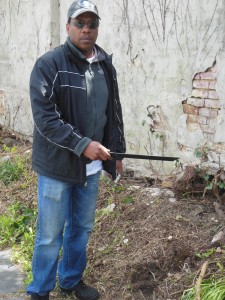 Holding tha machete which was found hidden the brush behind Zion Church. (Anthony C. Hayes)