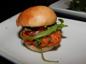 The Alaskan Salmon Cake Sliders have a hint of lemon and dill and are served with homemade tartar sauce, arugula, green onions and roma tomatoes. (Jon Gallo)