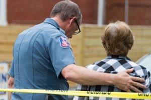 May 28, 2018, Ellicott City, Md. - Howard County Police Dept. Major E.A. Jones consoles a business owner during the aftermath of the May 27th storm that produced over 8 inches of rainfall in a very short period of time across Howard County. The downpour caused massive flooding through Ellicott City devastating Main Street homes and business. This flood is reminiscent of the 2016 flood from which the community still haven't fully recovered. (Mike Jordan / BPE)