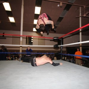 Blood goes airborn for "Senton Splash" against a reeling Jason Drake. (William Mendrzycki)