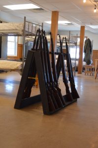 WWII-era rifles rest in a barrack gun rack at Ft. Indiantown Gap. The rifles are used by reenactors at the annual Battle of the Bulge event.(Anthony C. Hayes) 