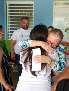 Angelique Sina of the Friends of Puerto Rico gets a hug from a grateful recipient of help.