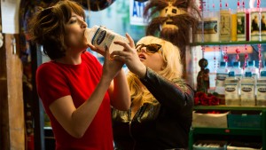 Rebel Wilson shows Dakota Johnson a great remedy for a hangover in How To Be Single. (Warner Bros.)