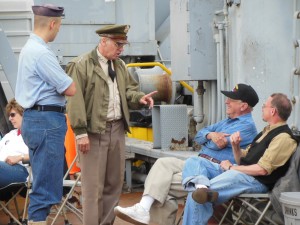 Reenactor Jim Callear as Gen. Omar Bradley discusses the Korean War with veteran Roy Wagner and his son Jim. (Anthony C. Hayes)