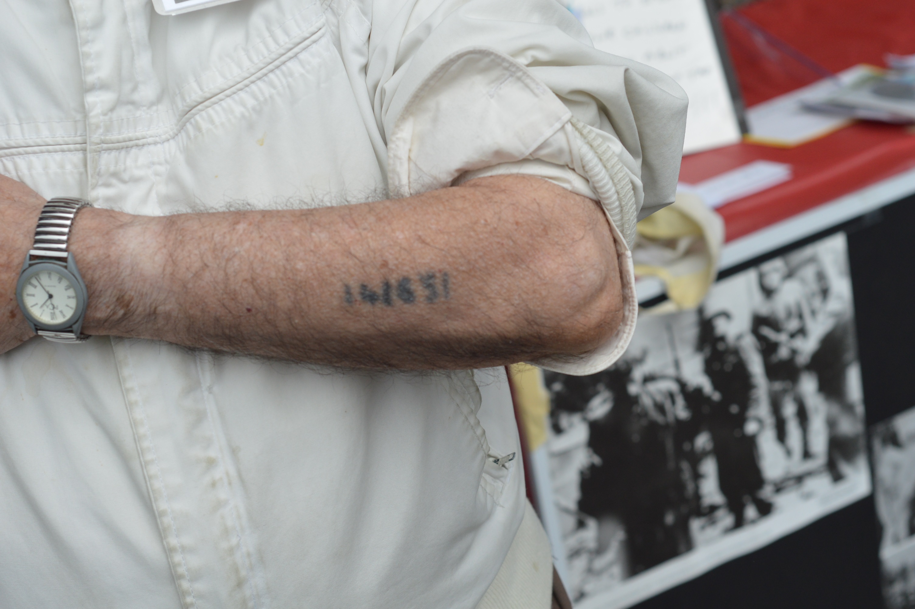 Holocaust survivor David Tuck shows the number tattooed on his arm by the Nazis (Anthony C. Hayes)