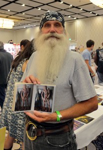 Collector Ernie Ford displays two photos of his extensive sci-fi costume collection. (Cheryl Fair)