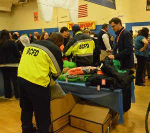 Baltimore City firefighters help distribute winter coats as part of Operation Warm. (Anthony C. Hayes) 