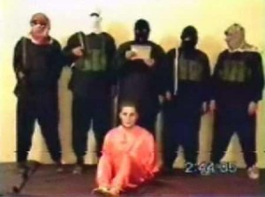 A screenshot from the 2004 hostage video, where Nick Berg was beheaded by al-Zarqawi's group. (Wikipedia)