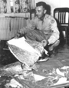 Major Jesse Marcel hold some of the debris recovered from the 1947 incident near Roswell, New Mexico.