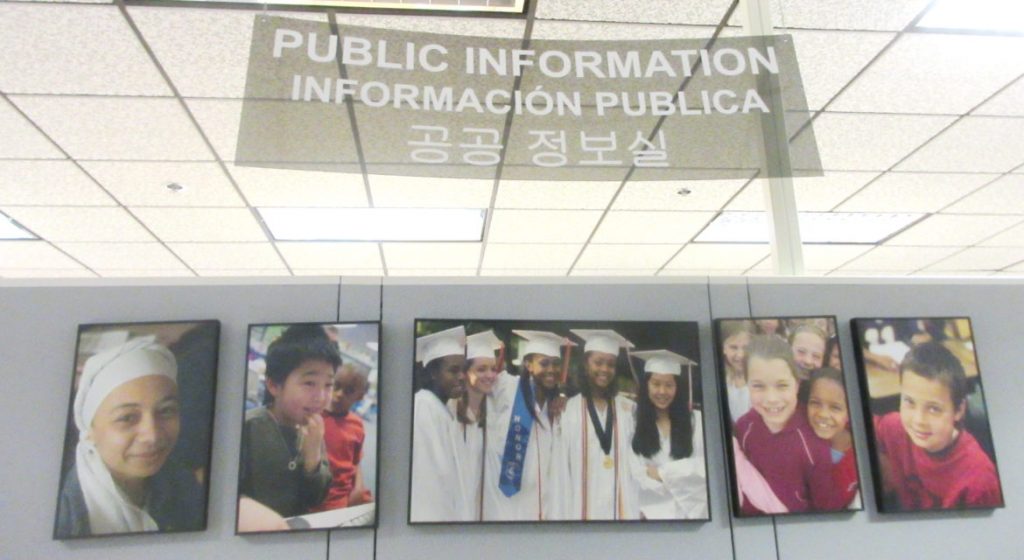 The sign in the public information office in the school system headquarters, in English, Spanish and Korean, typifies the diversity in local schools. Len Lazarick photo