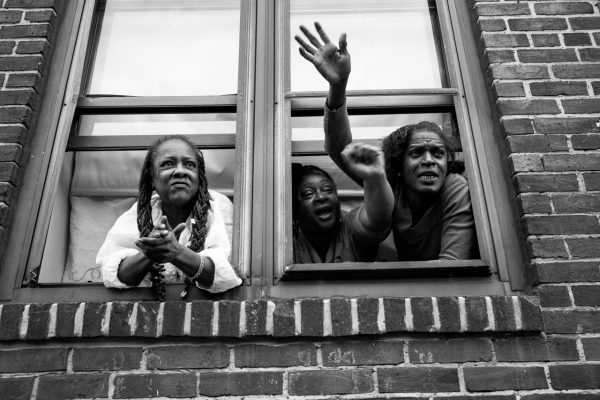 Baltimore women wave at passing protesters. (Sean Scheidt)