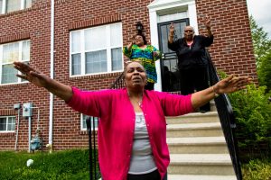 "One 67-year old woman in Sandtown with her hands outstretched was crying." (Sean Scheidt)