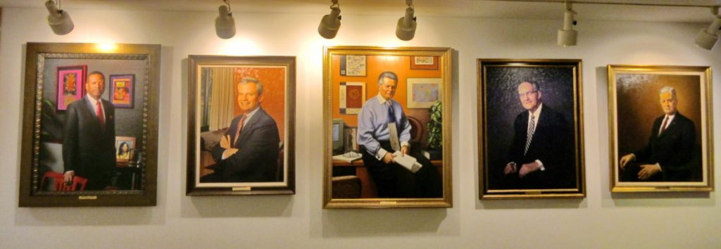 Portraits of past Howard County school superintendents hang in the Department of Education headquarters on Route 108. From right: John Yingling (1949-1968), M. Thomas Goedeke (1968-1984), Michael Hickey (1984-2000), John O’Rourke (2000-2004), and Sydney Cousin (2004-2012). Photo by Len Lazarick