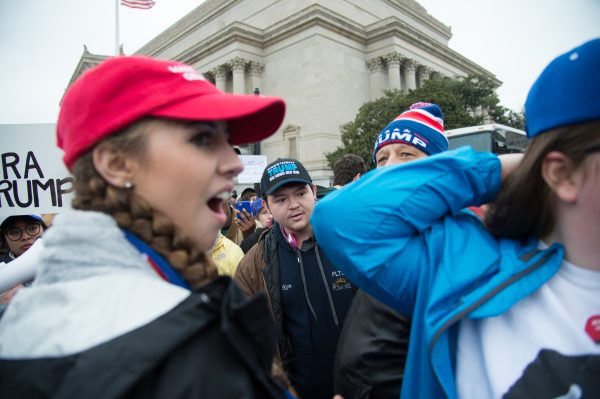 Inauguration Day: A Trump supporter (left) reacts after a fellow Trump supporter (right and just off frame) had her hair set on fire by a Trump protestor. The incident appeared to be accidental and the protestors apologized profusely but it is unclear how it happened. Nobody appeared to be smoking nor were there any other sources of flame. (Michael Jordan)