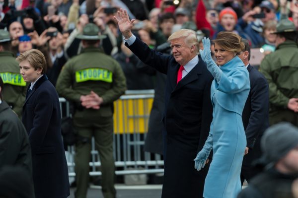 Inauguration Day: President and Mrs Trump wave to the crowd moments after exiting their vehicle to walk Past the Trump Hotel. This photo was taken at Pennsylvania Ave and 10th St NW. (Michael Jordan) 