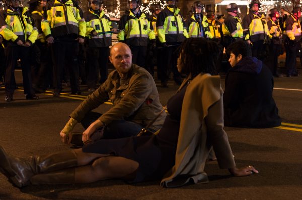 "Waiting them out" Protestors who were seemingly a part of the event at the Marriot hotel sit down in the intersection across from the Henley Park Hotel. This became a waiting game that lasted some time. (Michael Jordan)